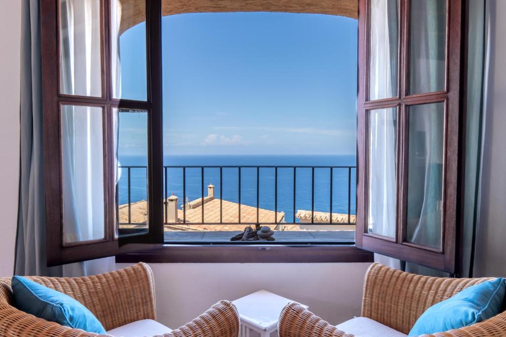 a room with a balcony with a view of the ocean at Son Borguny in Banyalbufar