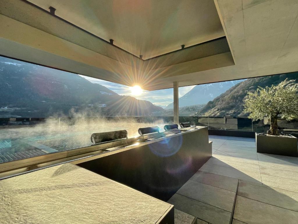 a patio with a view of a mountain in the background at Nutzhof - Mediterran Flair Hotel in Lagundo