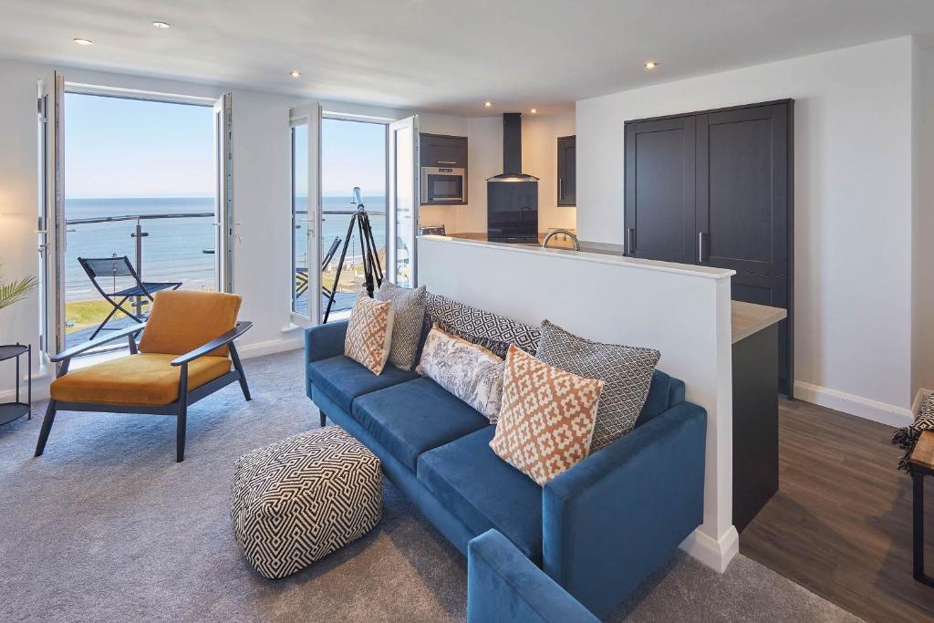 a living room with a couch and a view of the ocean at Host & Stay - The Waves in Whitby