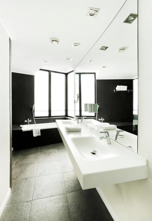 a bathroom with three sinks and a large mirror at Hotel Alimara in Barcelona