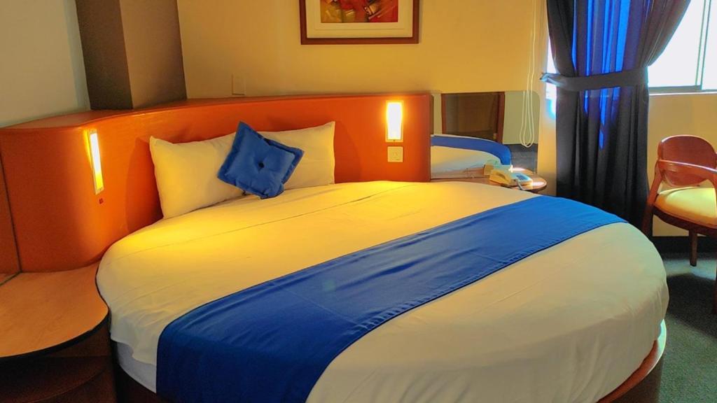 Postel nebo postele na pokoji v ubytování Blue Star Hotel