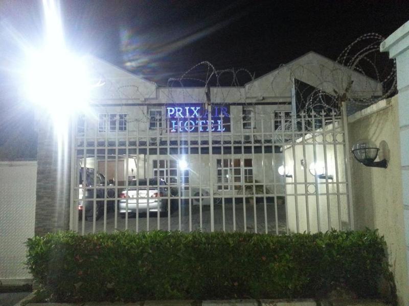 a building with a sign that reads play me hotel at night at Prixair Hotel Limited in Abuja