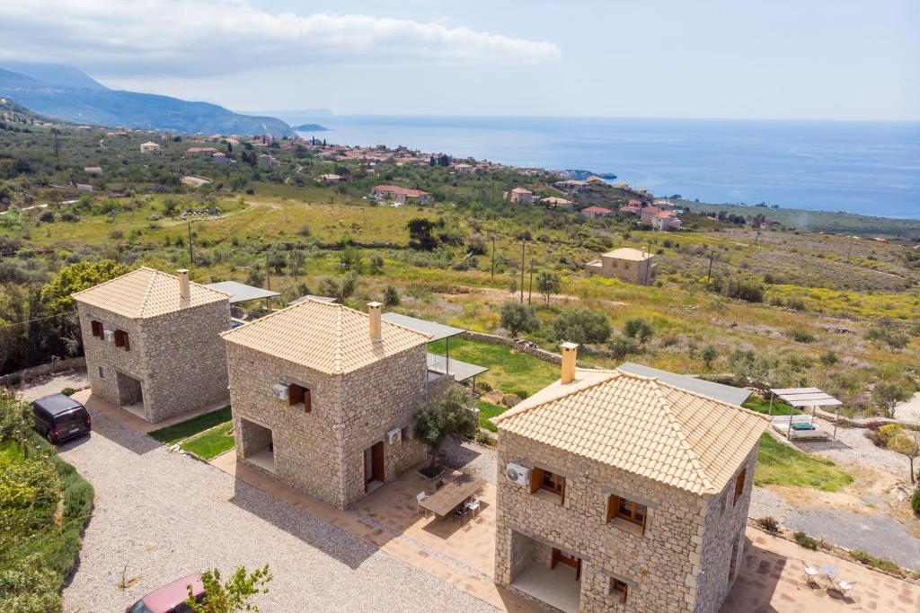 an aerial view of two houses with the ocean in the background at La Pietra Maisonettes in Neokhórion