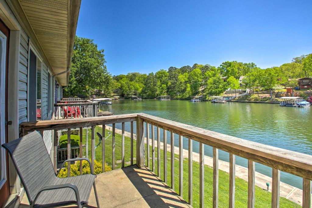 a porch with a bench and a view of a river at Quaint Hot Springs Condo on Lake Hamilton! in Hot Springs