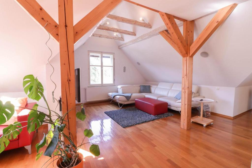 a living room with a white couch and wooden beams at Apartment in the heart of Bled with views in Bled