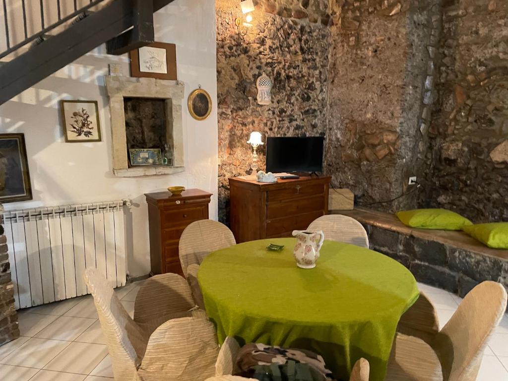 a living room with a green table and chairs at Antica Casa Centro in Catania