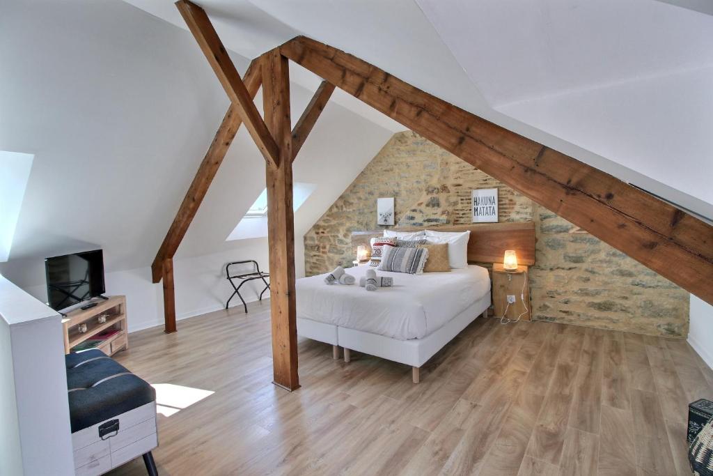 a bedroom with a white bed in a attic at Appartement en duplex centre-ville BOHEME in Vannes