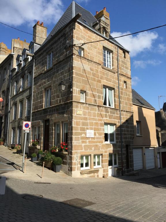 an old brick building on a city street at La Maison des Matignon 1 in Granville