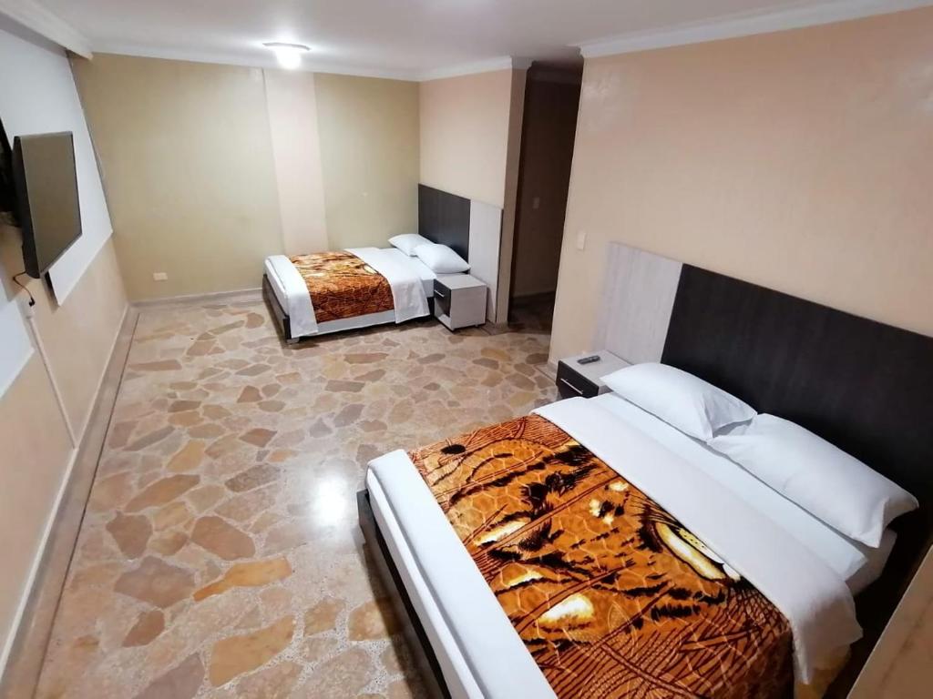 Postel nebo postele na pokoji v ubytování HOTEL GOLDEN SUITE