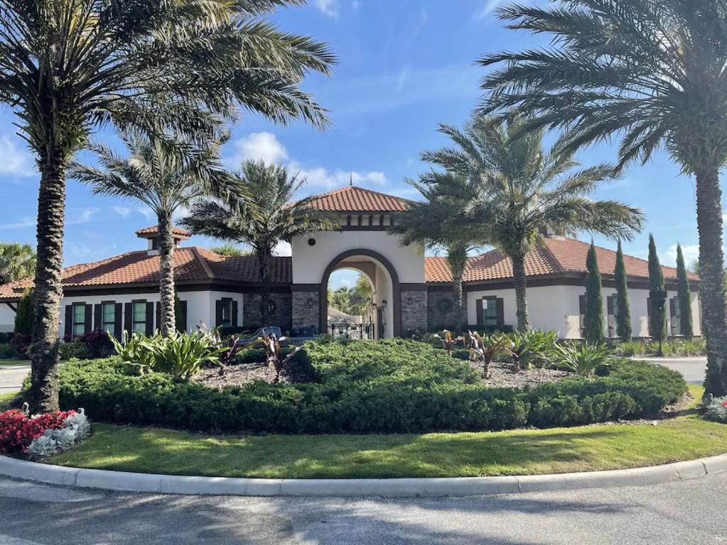 a house with palm trees in front of it at Havilah Vacation Villas Resort Club in Davenport