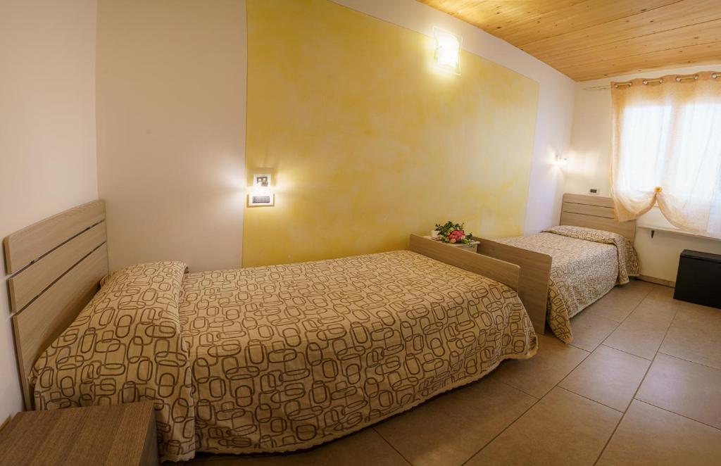 Posteľ alebo postele v izbe v ubytovaní Albergo La Lampara