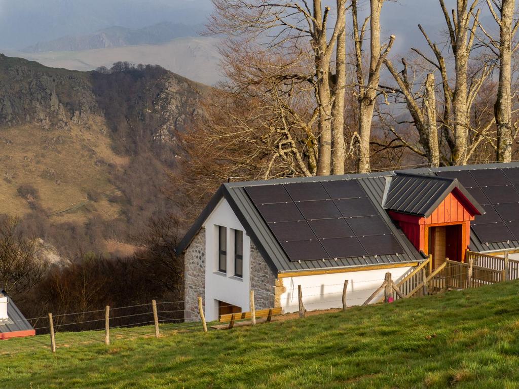 a house with solar panels on the side of a hill at AUBERGE BORDA in Saint-Michel
