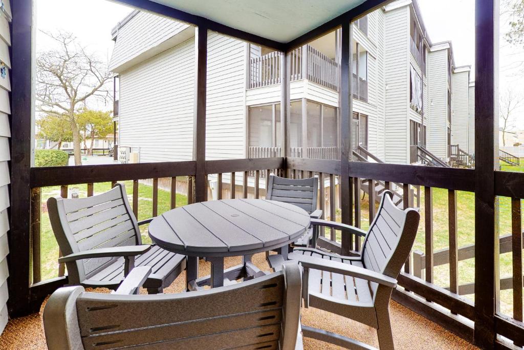a patio with a table and chairs on a balcony at Our Place at the Beach I-101 in Ocean City