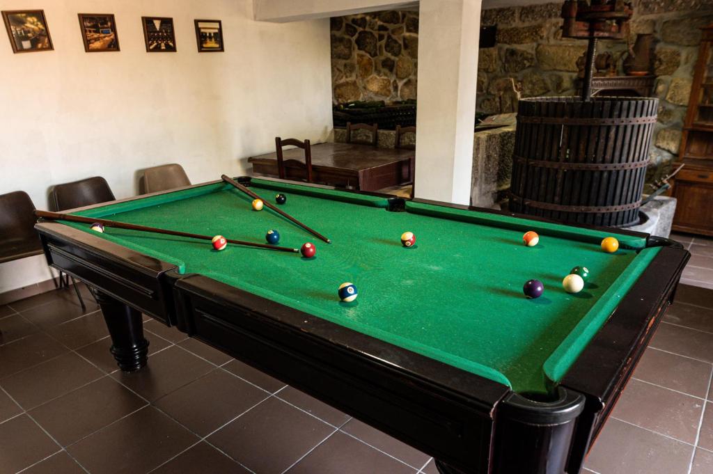 a pool table with balls on it in a room at Leira da Cruz Grande in Castelo de Paiva
