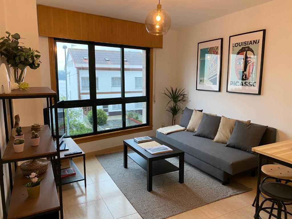 a living room with a couch and a table at Luky Miño in Miño