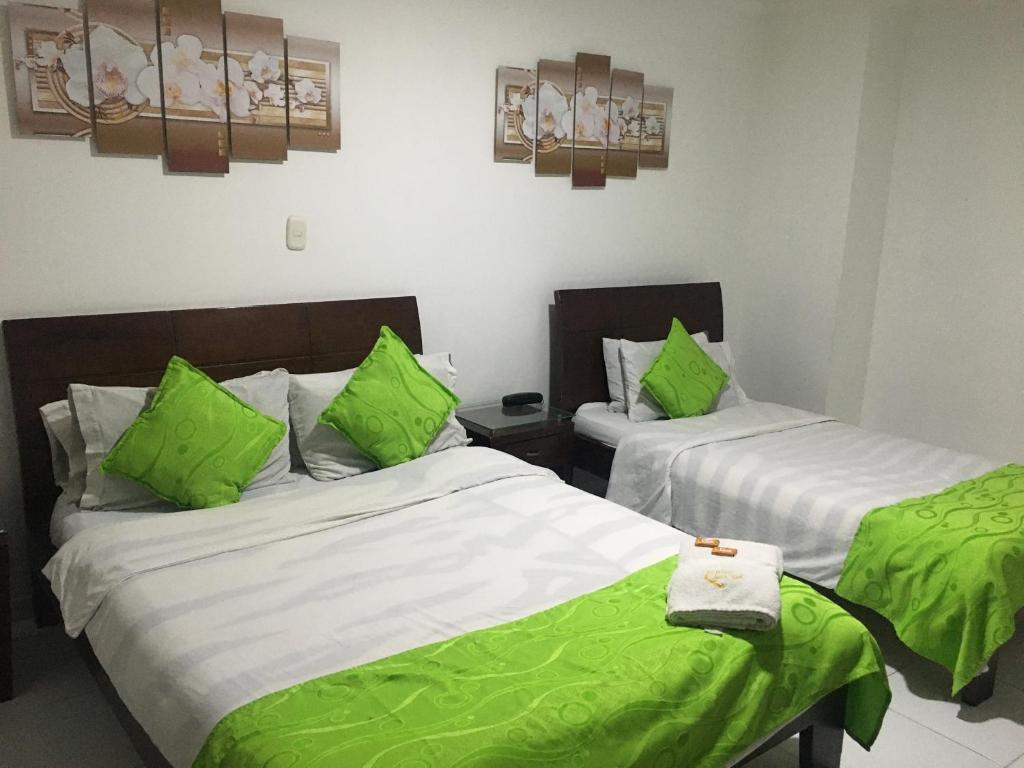 Postel nebo postele na pokoji v ubytování Hotel Fénix Real Bogotá