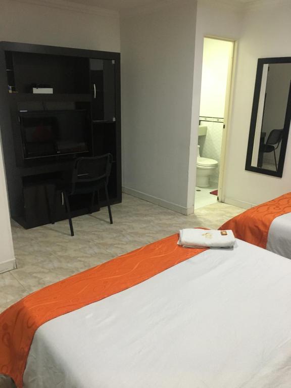 Postel nebo postele na pokoji v ubytování Hotel Fénix Real Bogotá