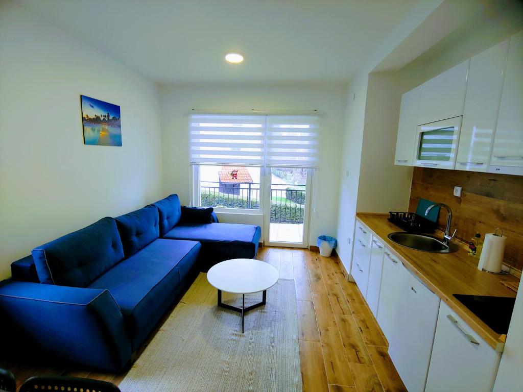 sala de estar con sofá azul y mesa en MK Zlatibor en Zlatibor