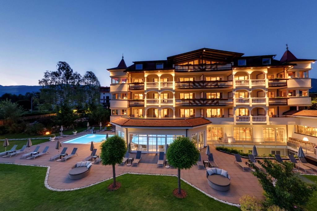 an aerial view of a hotel with a pool at Majestic Hotel & Spa Resort in Brunico