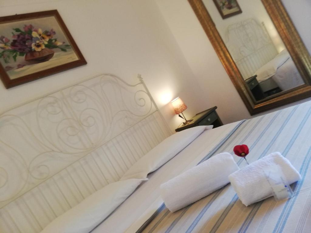 a bedroom with a bed with two pillows on it at I Vespri in Catania