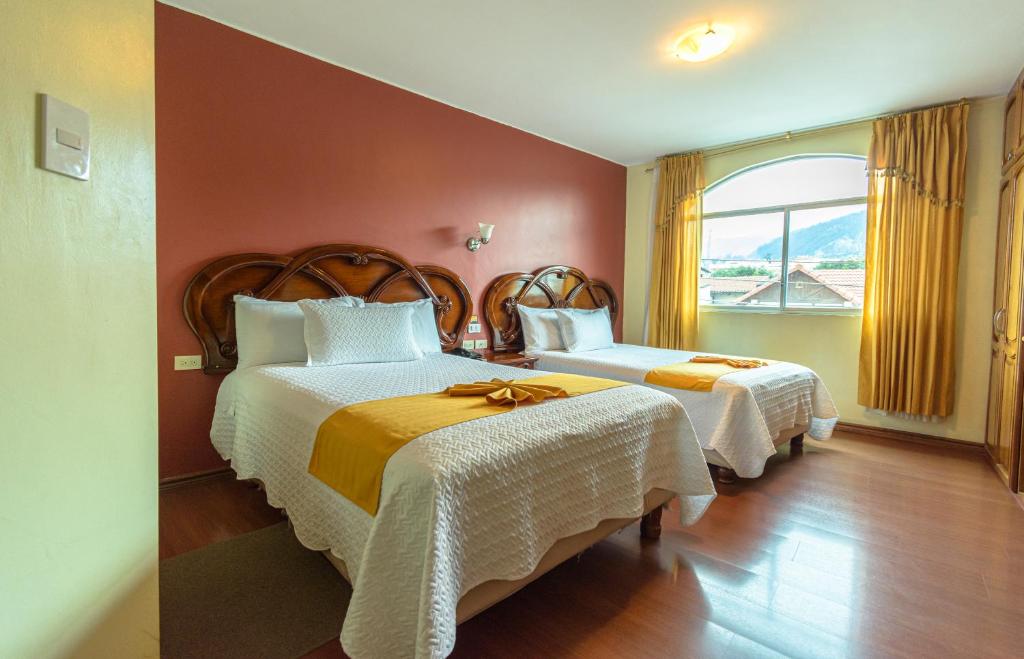 Postel nebo postele na pokoji v ubytování Hotel Cumbayá Sanvy