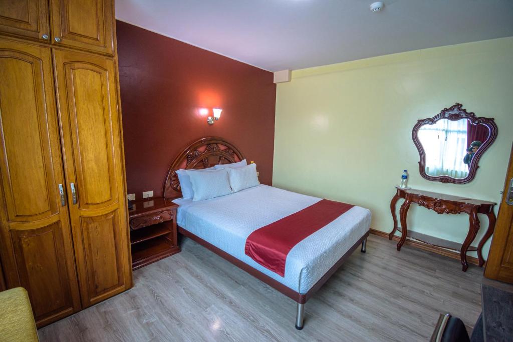 Postel nebo postele na pokoji v ubytování Hotel Cumbayá Sanvy