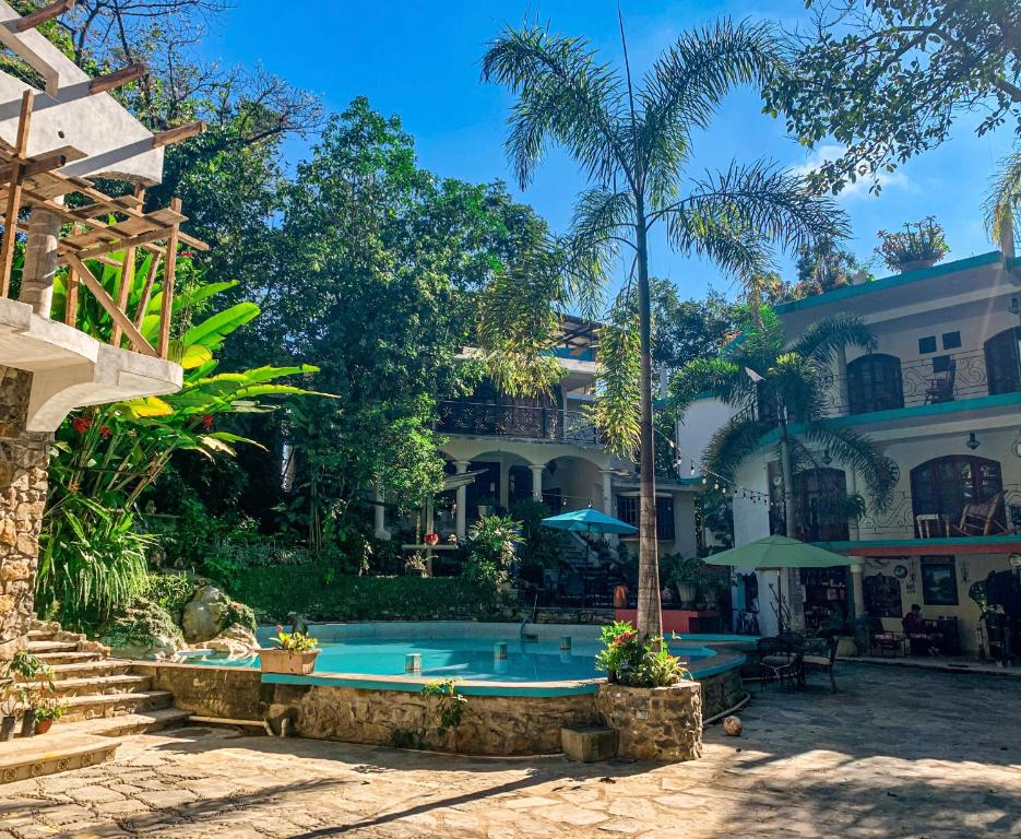 a house with a swimming pool in front of it at Hotel Paraíso Encantado in Xilitla