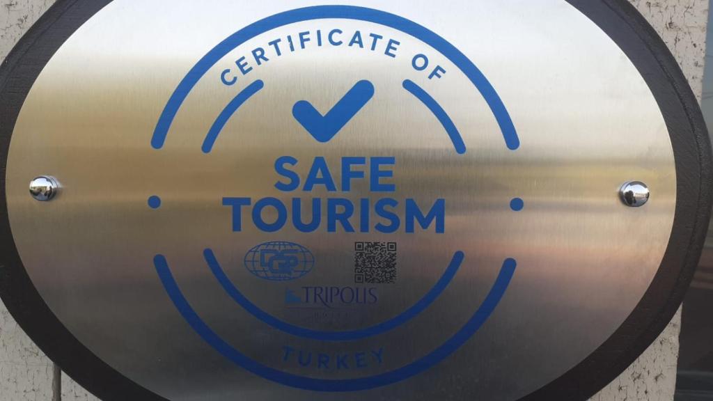 a safe tourism sign on a metal door at Tripolis Hotel in Pamukkale