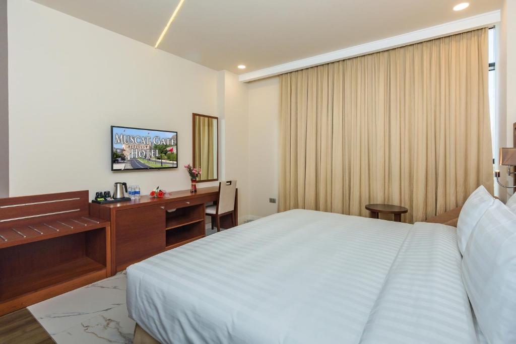 Postel nebo postele na pokoji v ubytování Muscat Gate Hotel