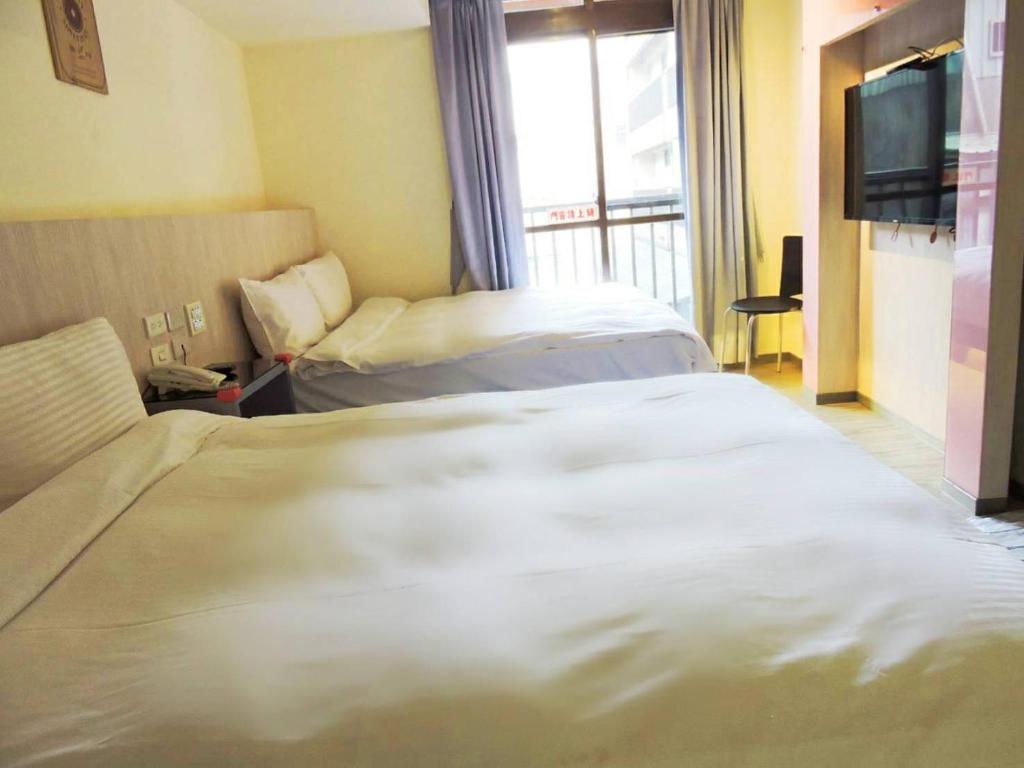 Postel nebo postele na pokoji v ubytování Walker Hotel - Chenggong