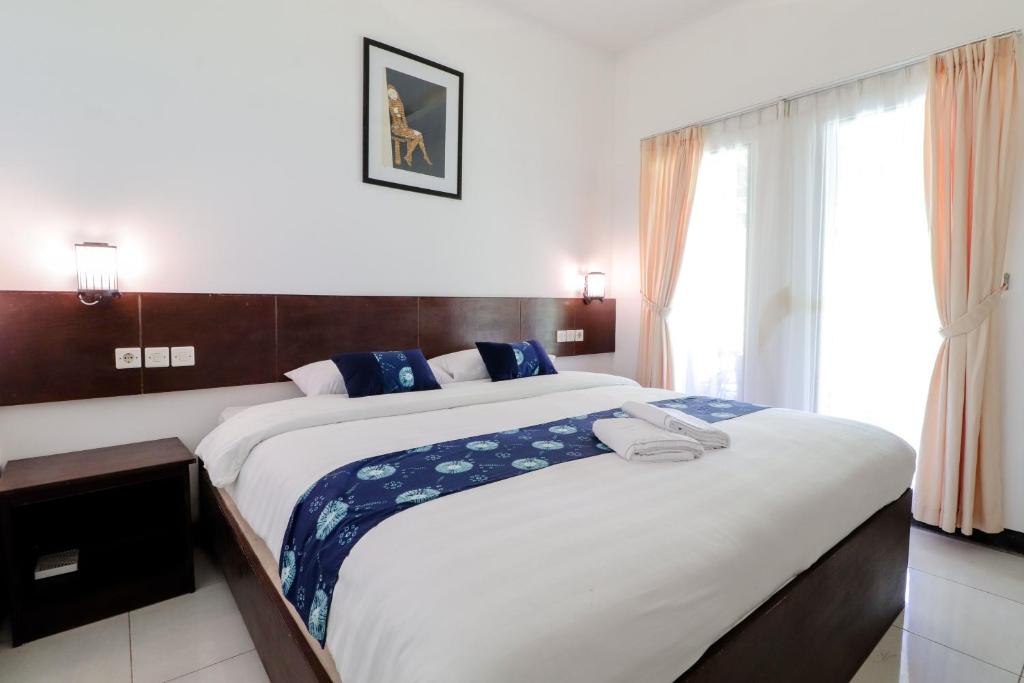 Postel nebo postele na pokoji v ubytování Balkondes Kenalan