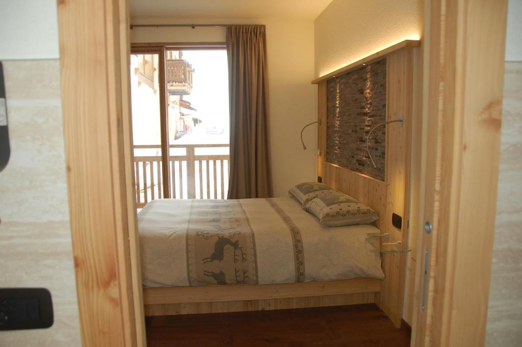 a bedroom with a bed and a window at Hotel Carpe Diem in Livigno