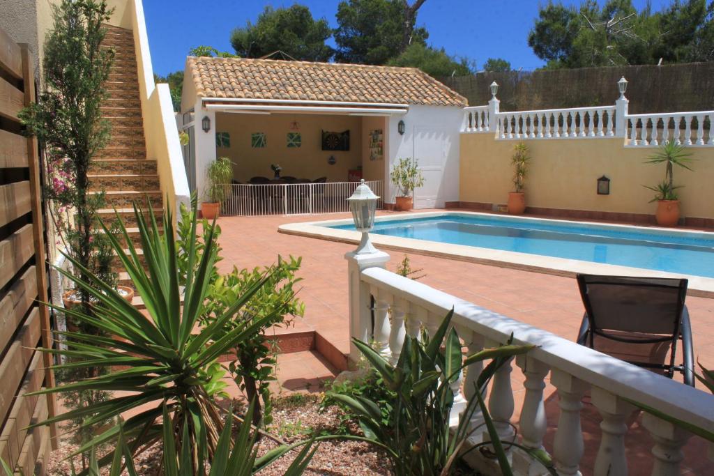 a villa with a swimming pool and a house at Villa Castillo Nuevo with optional Heated Private Pool in San Miguel de Salinas