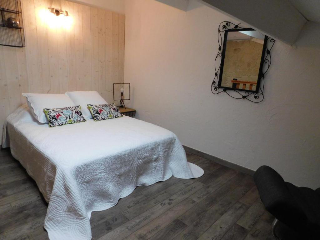 Schlafzimmer mit einem weißen Bett und einem Spiegel in der Unterkunft LA MAISON DU LAC climatisée et WiFi gd F3 in Port-la-Nouvelle