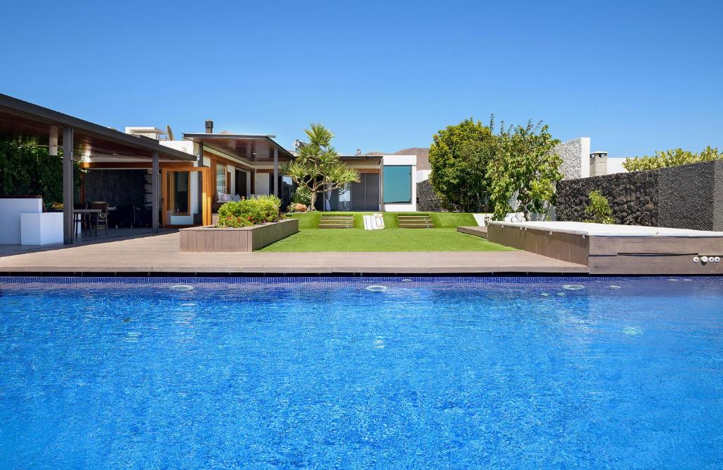 a swimming pool in the backyard of a house at Luxury and Harmony House in Playa Blanca