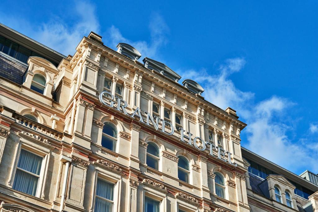 a large building with a balcony on the side of it at The Grand Hotel Birmingham in Birmingham