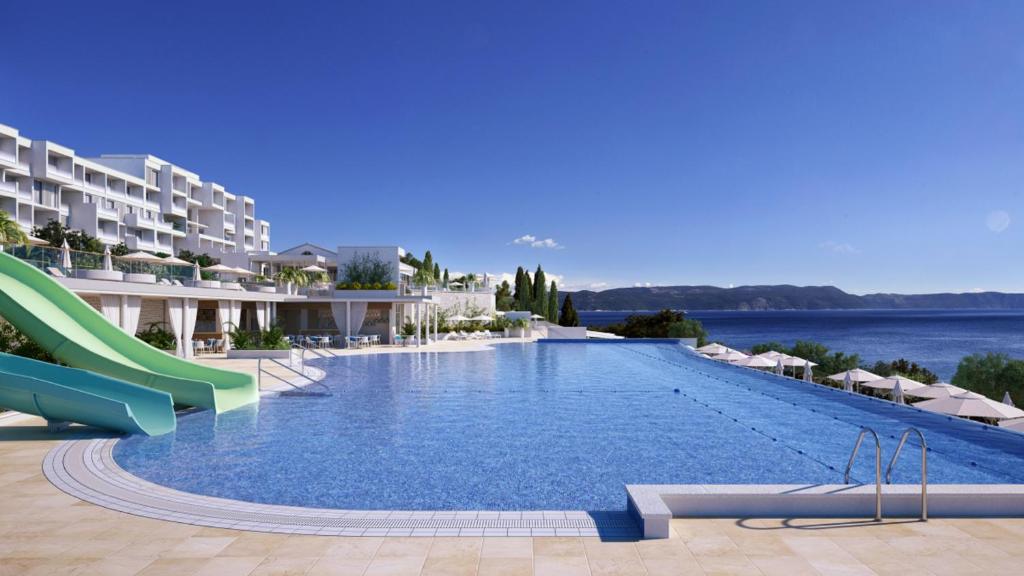 a swimming pool at a resort with a slide at Valamar Bellevue Resort in Rabac