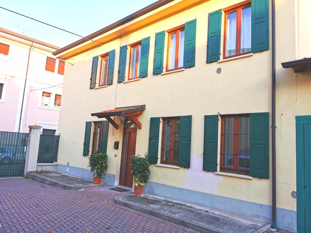 a building with green and colorful windows on it at Flat blue in Verona