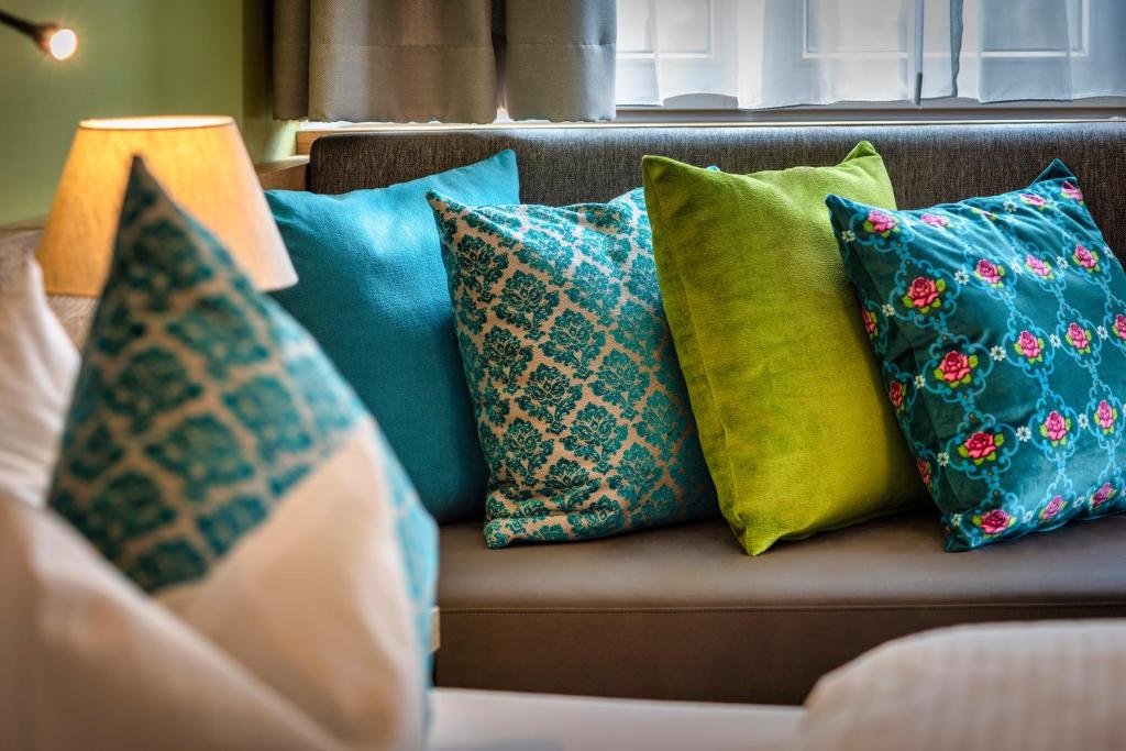 a group of pillows sitting on a couch at Ruhpoldinger Hof in Ruhpolding