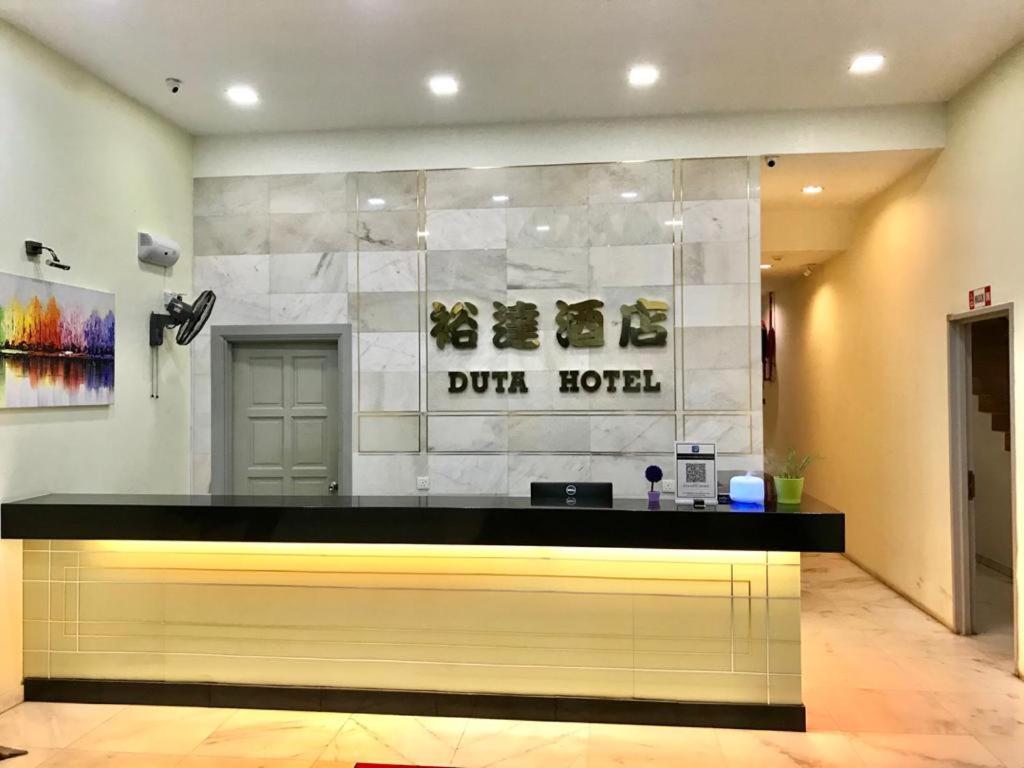 a store front with a counter with shoes on the wall at DUTA HOTEL in Kuala Lumpur