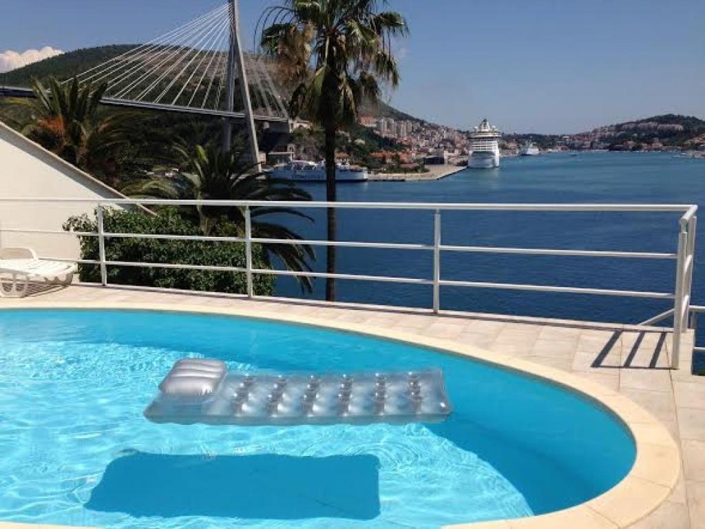 a swimming pool with a view of the water at Apartments Lozica in Dubrovnik