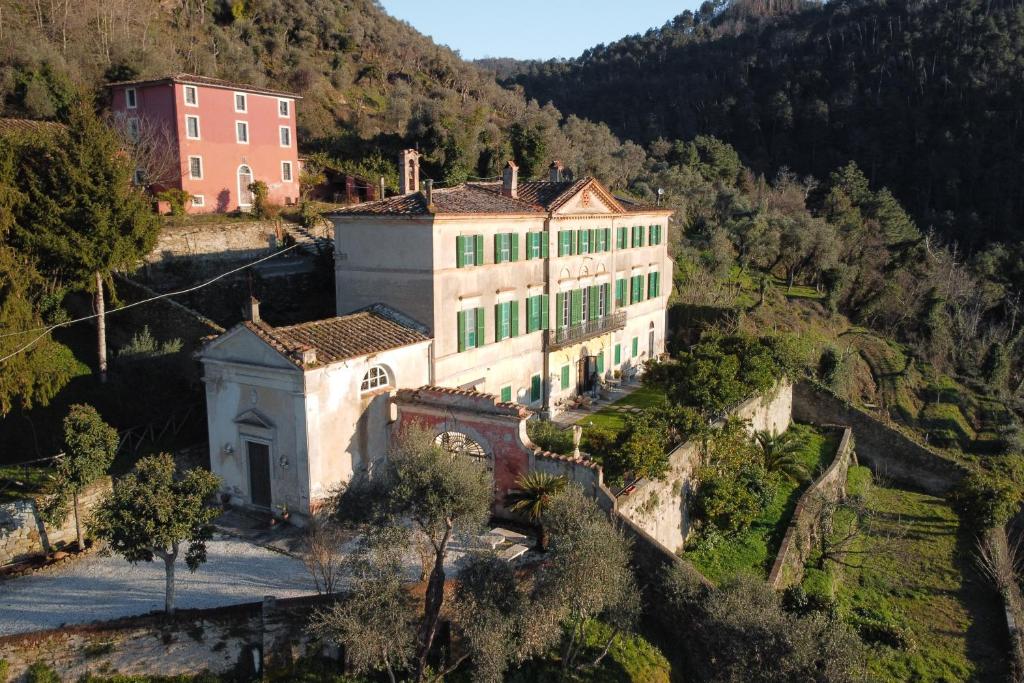 a large building on the side of a mountain at Agriturismo Villa Cavallini in Camaiore