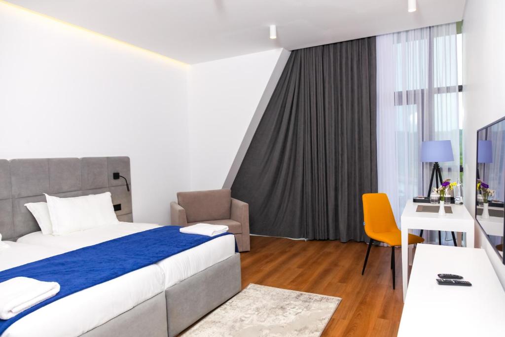 a hotel room with a bed and a desk at N Hotel BY NOSHI in Rinas