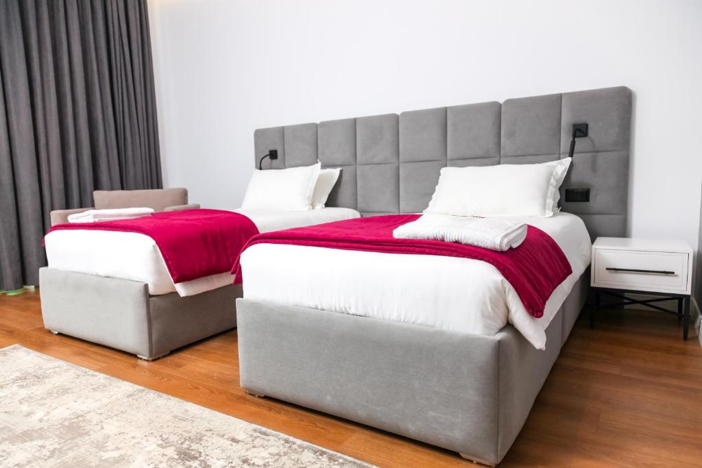 a bedroom with two beds and a large headboard at N Hotel BY NOSHI in Rinas