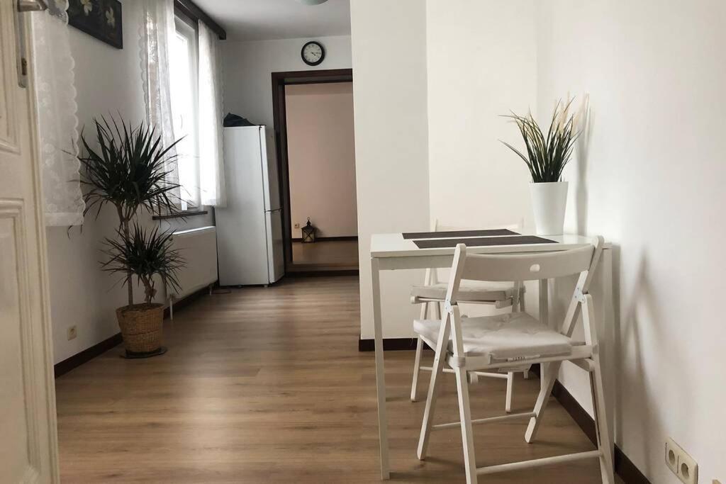 a kitchen with a table and chairs and a refrigerator at Easy comfort in Brussels