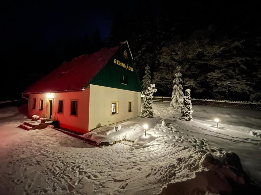 een klein huis in de sneeuw 's nachts bij Ferienhaus Bikehütte Rehnhäusl in Fürstenwalde