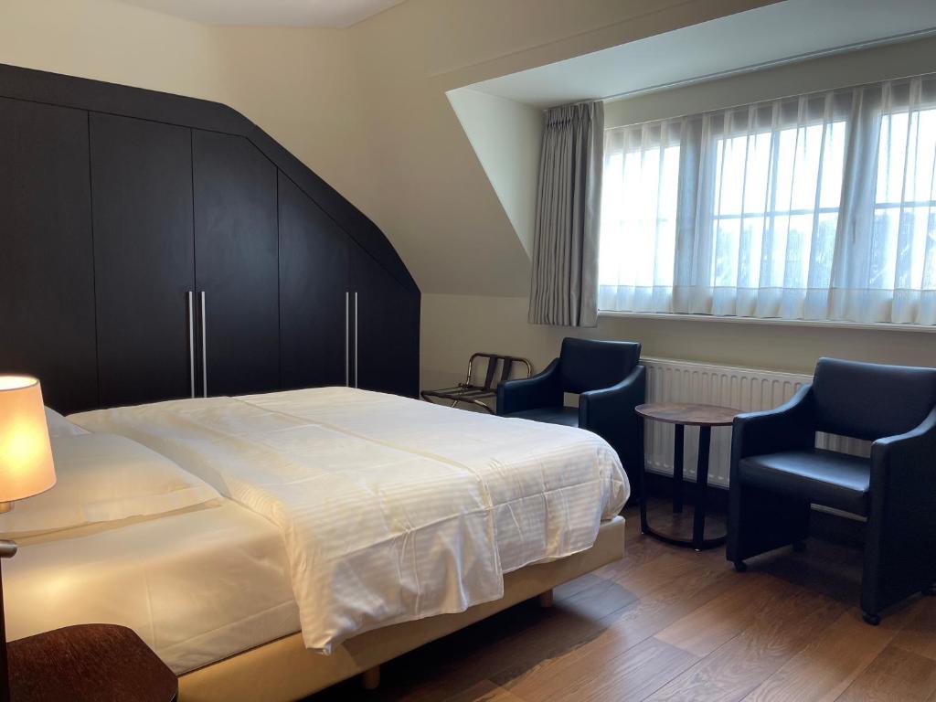 Postel nebo postele na pokoji v ubytování Villa Hotel