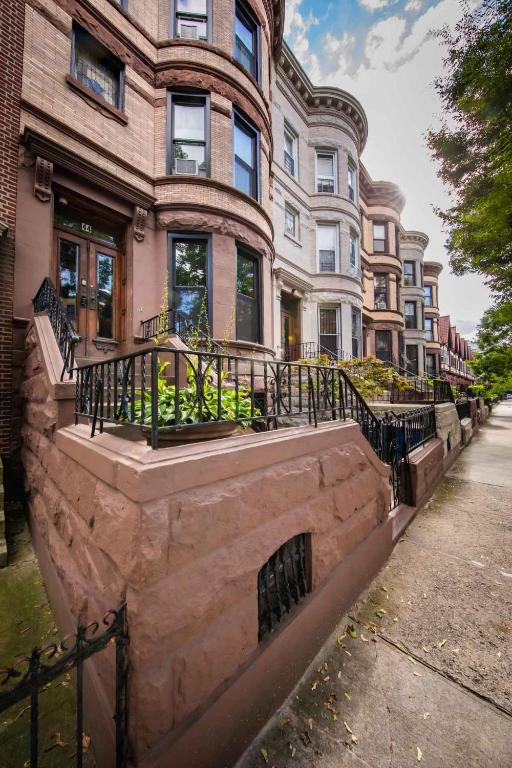 a large brick building with a staircase in front of it at PLG House in Brooklyn