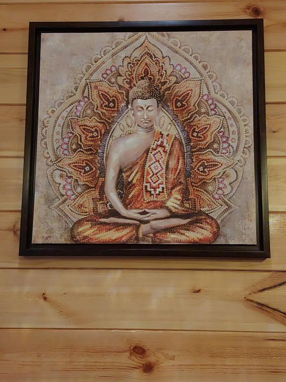 a painting of a buddha on a wall at Adhvasaha Beach Spa Resort in Port Blair