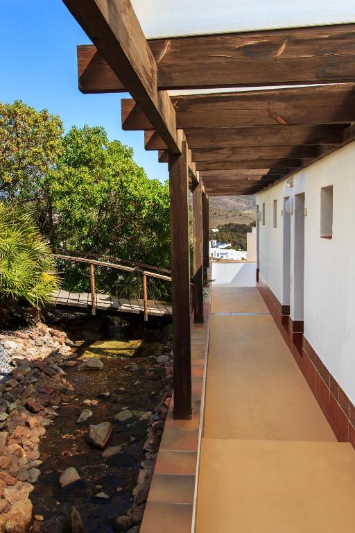a porch with a bridge over a river at Hostal El Dorado in San José